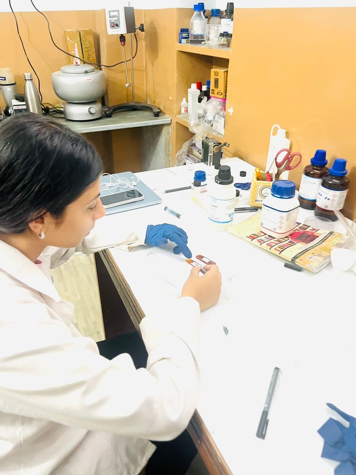 Student cutting a sample at the lab bench