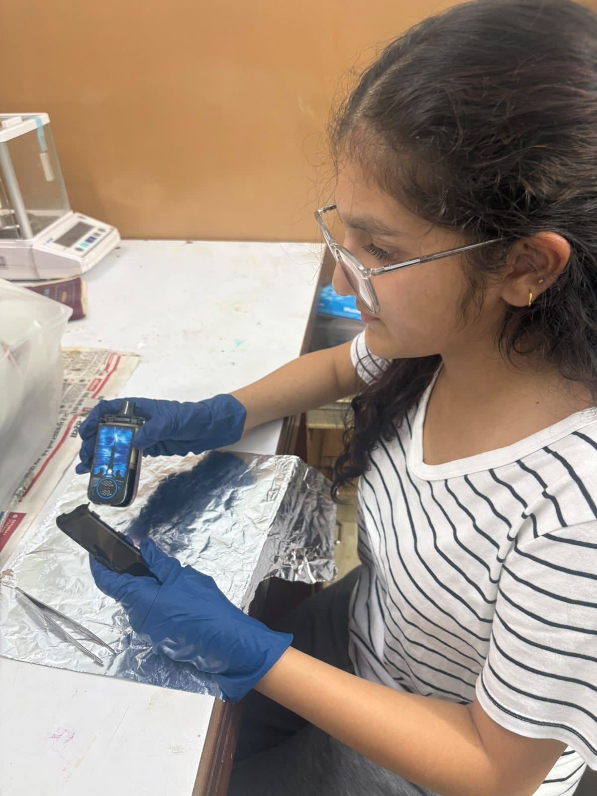 Student taking a reading from a sample on foil
