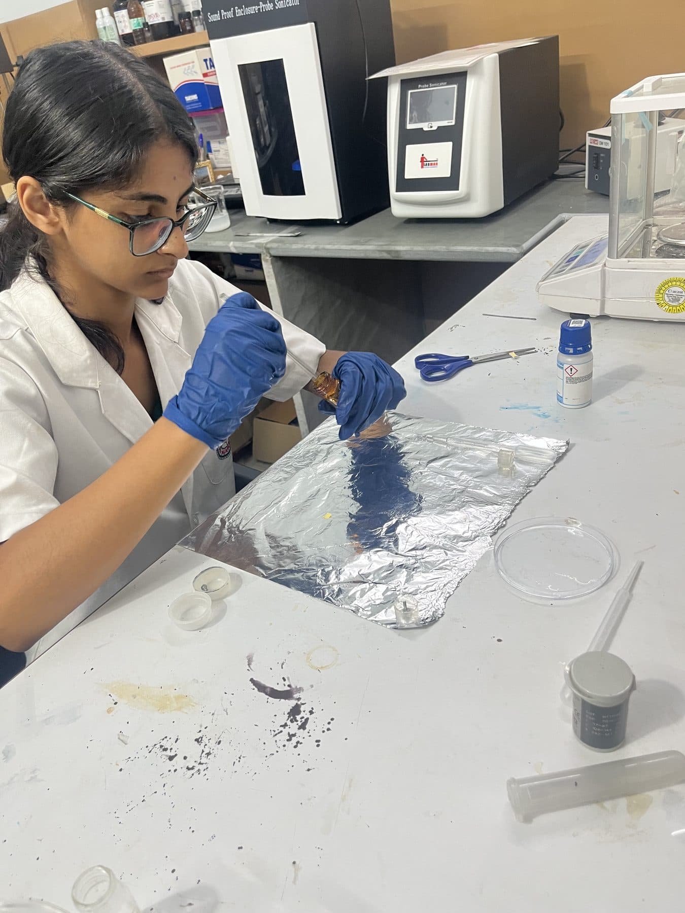 Student preparing samples on aluminium foil
