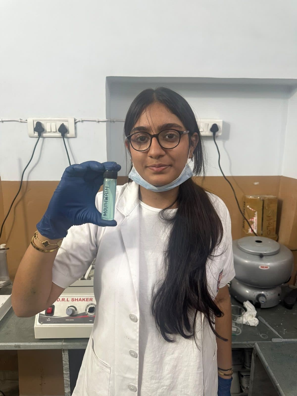 Student holding up a vial of her sample