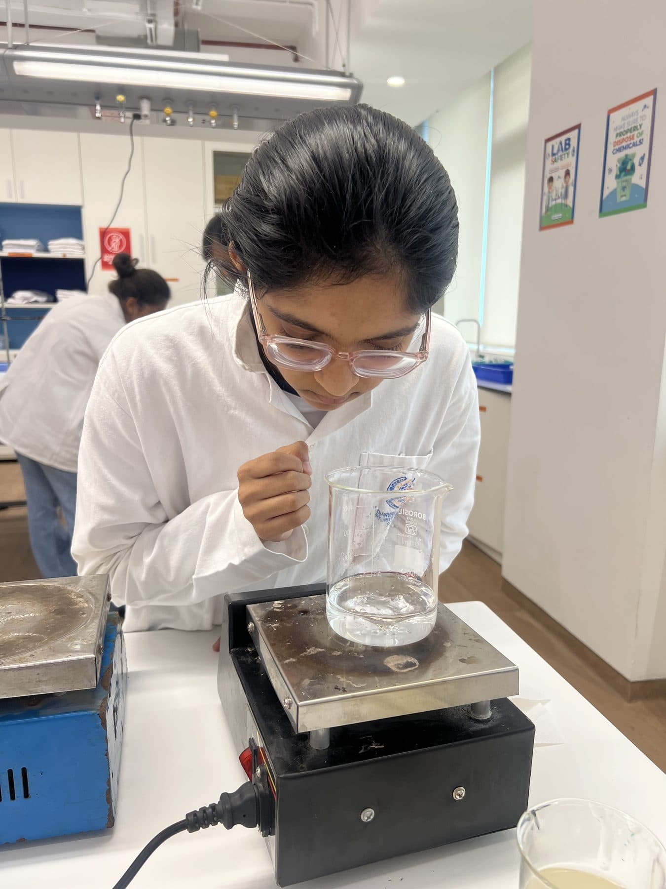 Student watching a solution mix on a magnetic stirrer