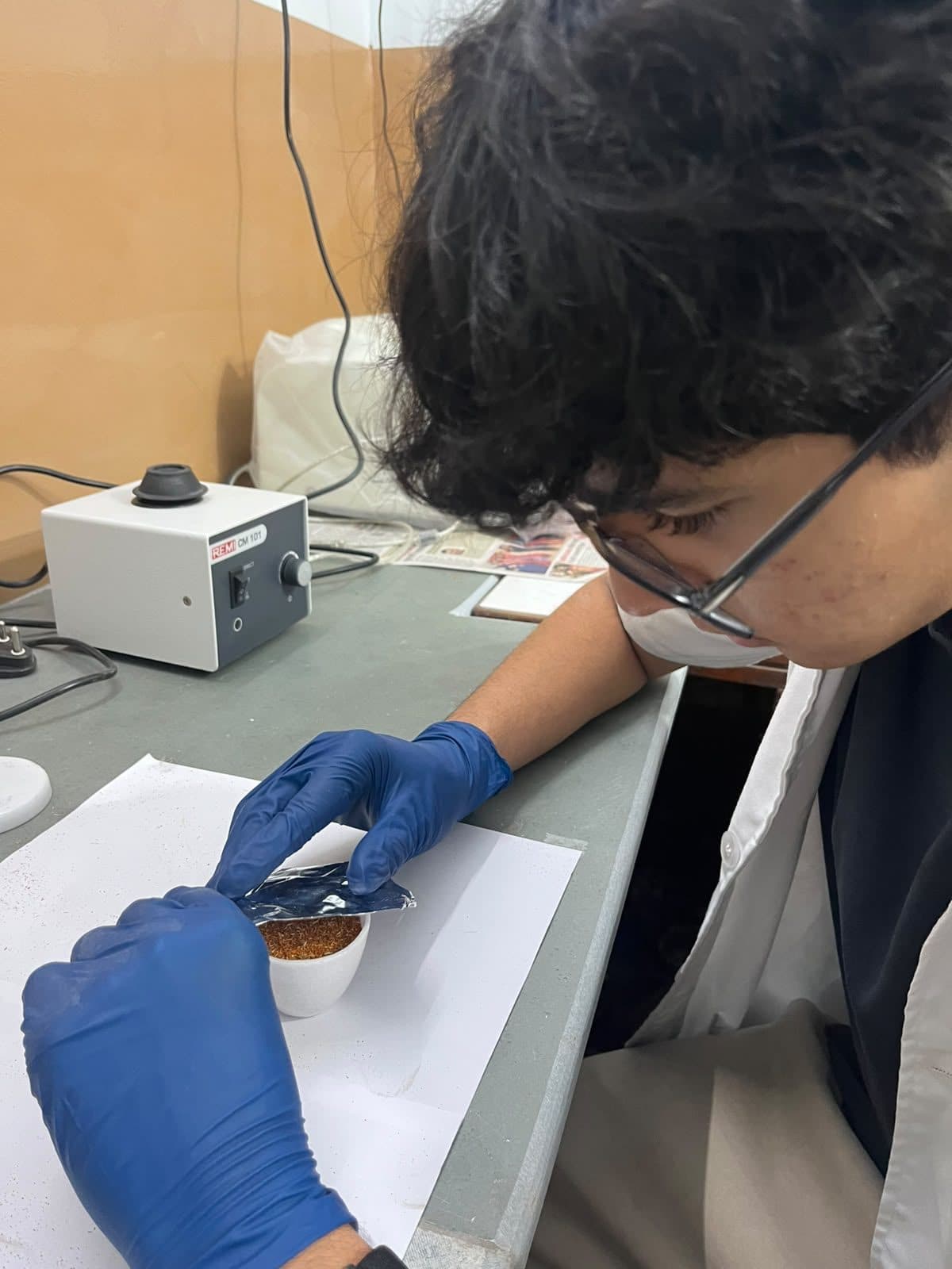 Student handling a sample with tweezers